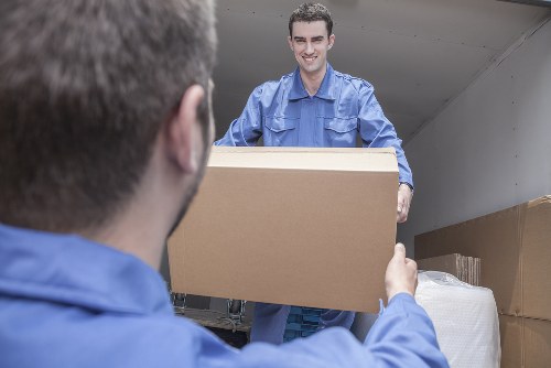 Trained moving staff handling furniture carefully with gloves