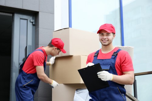 Professional movers carrying boxes in a Finsbury flat move