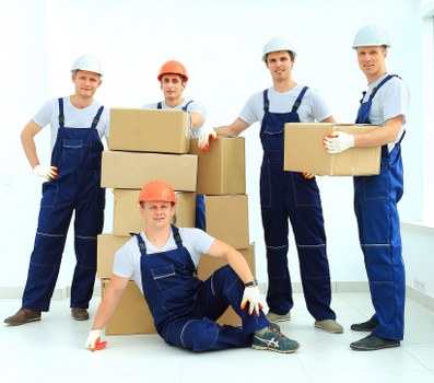 Office relocation scene with movers handling desks and equipment in Finsbury