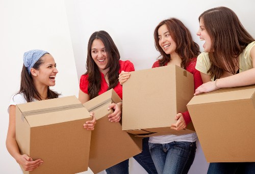 Professional movers unloading items at a Finsbury apartment building