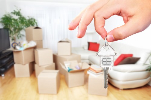 Professional movers carrying furniture from a flat in Finsbury