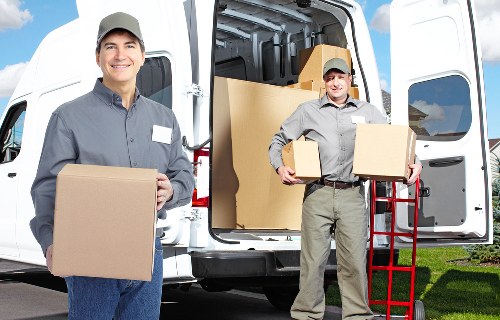 Prepared furniture and boxed items ready for collection by a local van service