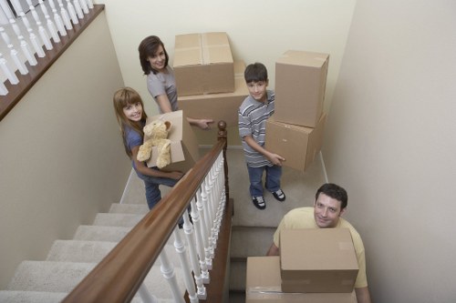 Removal team handling boxes and furniture in a central London street